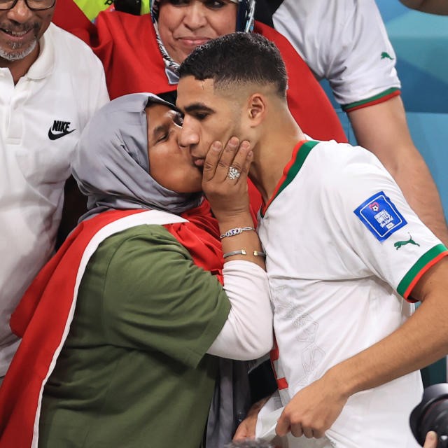 a Mother kissing her son after a match